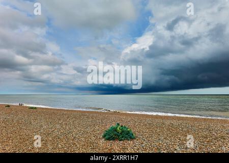 Vivid Coastal Scene with Dramatic Cloud Patterns Over the Ocean at Aldeburgh beach, Suffolk, England Stock Photo