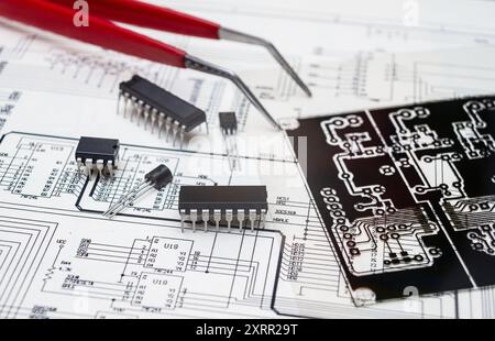 Electronic components and tools on an engineering blueprint for circuit board design. Stock Photo