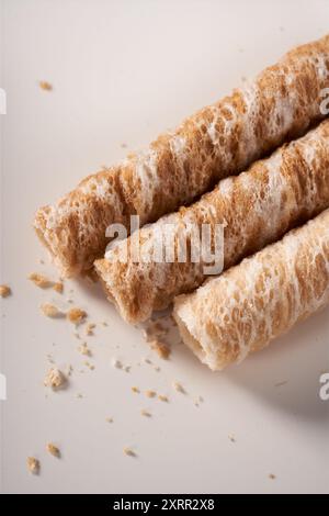 Crispy and delicious coconut crispy egg roll snack close up on white background Stock Photo