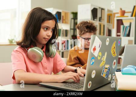 Teen Girl using Laptop in School Stock Photo