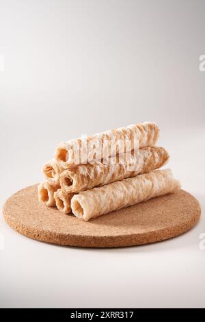 Crispy and delicious coconut crispy egg roll snack close up on white background Stock Photo
