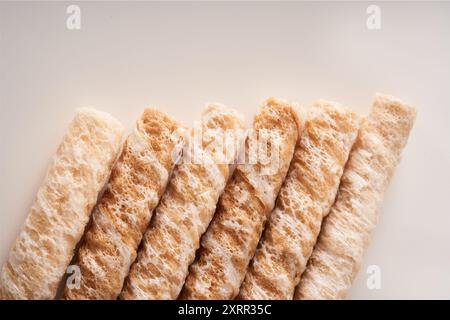 Crispy and delicious coconut crispy egg roll snack close up on white background Stock Photo