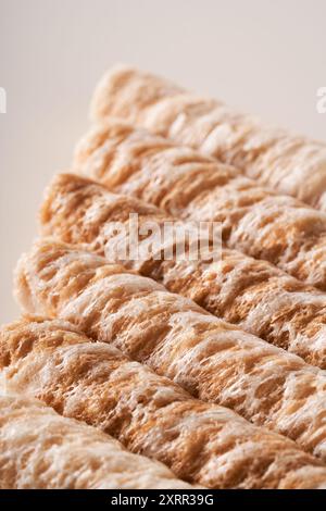 Crispy and delicious coconut crispy egg roll snack close up on white background Stock Photo