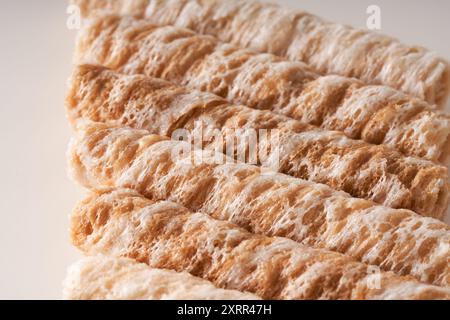 Crispy and delicious coconut crispy egg roll snack close up on white background Stock Photo