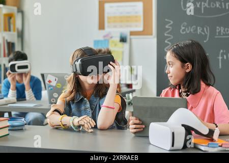Girls using Virtual Reality Technology in School Stock Photo