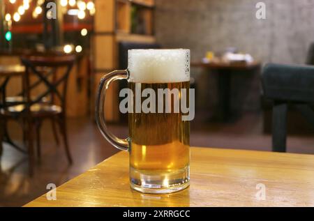 Glass of chilled draft beer Isolated on wooden table Stock Photo