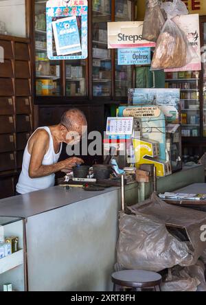 Old man in a chinese medical hall, Penang island, George Town, Malaysia Stock Photo