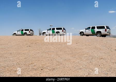 Three Border Patrol vehicles parked near the Mexico–United States border in the city of Nogales, Arizona Stock Photo