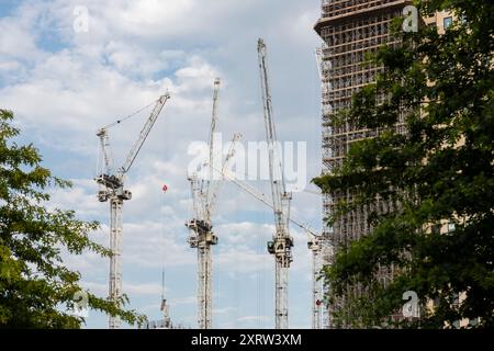 Looking up to cranes against the skyline on a constrcution site in London, UK. Stock Photo