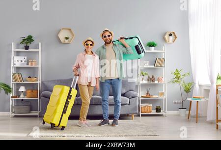 Happy family couple with packed up suitcases are ready for their summer vacation Stock Photo