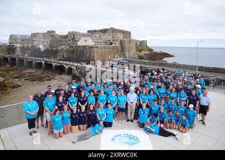 The Duchess of Edinburgh (centre) poses for a photograph with members of the Association Of Sail Training Organisations at Guernsey harbour after a trip on the Ocean Youth Trust South's vessel the Prolific, during her visit to Guernsey. Picture date: Monday August 12, 2024. Stock Photo