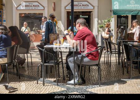 People Sat Outside At The Bakery Cafe Fabrica da Nata A Street Cafe In Lisbon Portugal Stock Photo