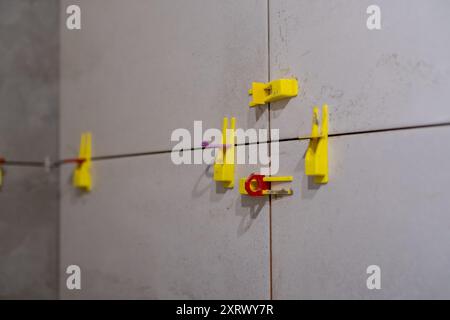 Close-up of tile leveling system with plastic clips and wedges in place.  Stock Photo
