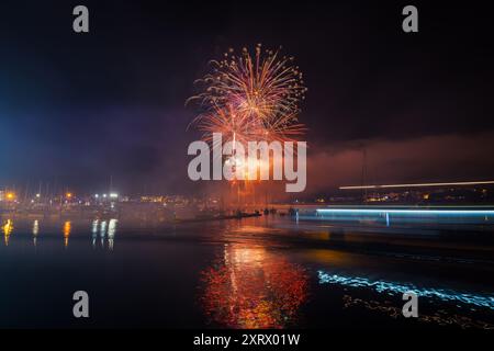 Long exposure shot of colorful fireworks over the sea for the local festivities in Portonovo, Sanxenxo, Galicia. Stock Photo