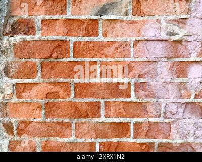 A brick wall with a white line in the middle, providing space for text. Perfect for creating a bold and striking background for your message. Stock Photo