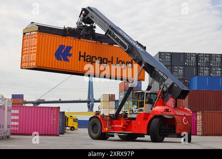 Hamburg, Germany. 08th Aug, 2024. A container stacker transports a container at the DB Schenker logistics center in the Port of Hamburg at DCP Dettmer Container Packing GmbH in the Port of Hamburg. Credit: Christian Charisius/dpa/Alamy Live News Stock Photo