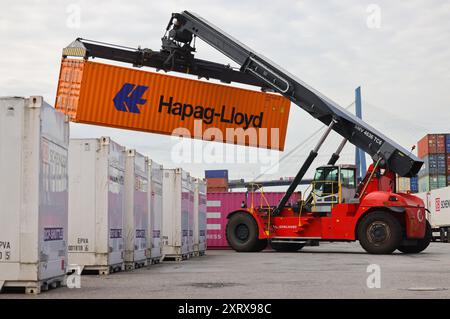 Hamburg, Germany. 08th Aug, 2024. A container stacker transports a container at the DB Schenker logistics center in the Port of Hamburg at DCP Dettmer Container Packing GmbH in the Port of Hamburg. Credit: Christian Charisius/dpa/Alamy Live News Stock Photo