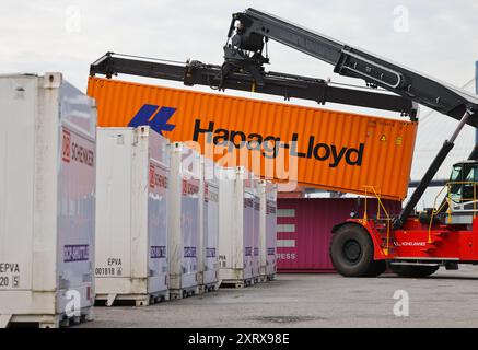 Hamburg, Germany. 08th Aug, 2024. A container stacker transports a container at the DB Schenker logistics center in the Port of Hamburg at DCP Dettmer Container Packing GmbH in the Port of Hamburg. Credit: Christian Charisius/dpa/Alamy Live News Stock Photo