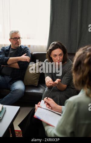 Discussing Strategies During Business Meeting with Colleagues Stock Photo