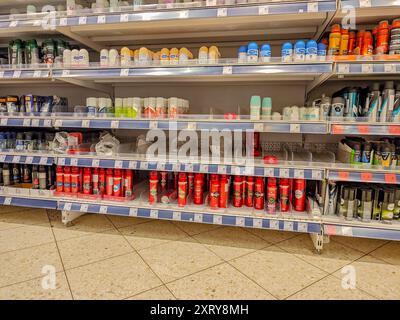 08 12 2024 - Kaunas, Lithuania. Half-empty store shelves at a supermarket. Goods deficit. Empty shelves after clearance sale campaign Stock Photo