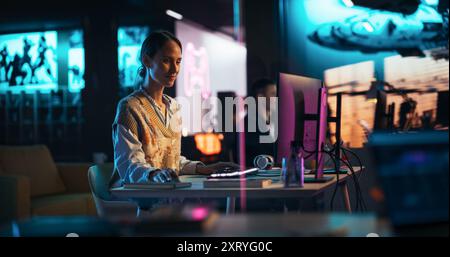 Portrait of a Beautiful Happy Female Project Manager Working in Creative Agency, Reviewing Marketing Strategy. Lead Specialist Using Desktop Computer, Analysing Data, Thinking and Solving Problems Stock Photo