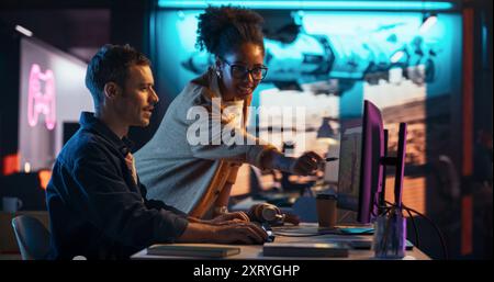 Portrait of Black Creative Director and Male Developer Talking About Work in Creative Agency. Two Stylish Diverse Employees Discussing Character Design on Computer in Game Development Company Stock Photo