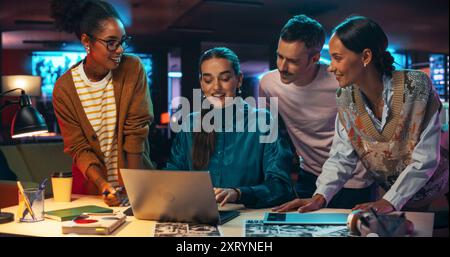 Multiethnic Group of People Use Laptop Computer to Discuss Work in Creative Office Conference Meeting Room. Diverse Colleagues Brainstorming, Solving Problems, Teamwork leads to Great Results Stock Photo