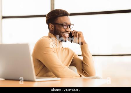 Cheerful black guy talking on the phone Stock Photo