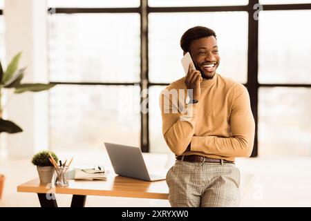 Happy black businessman talking on the phone Stock Photo