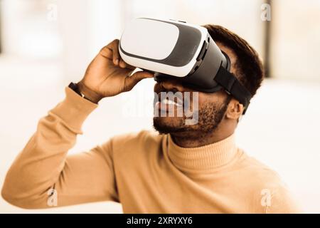 Afro manager wearing augmented reality goggles at office Stock Photo