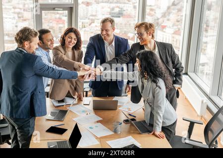 Diverse Business Team Stacking Hands in Modern Office Meeting Room Stock Photo