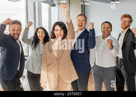 Diverse Group of Business Professionals Celebrating Success in Office Setting Stock Photo