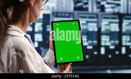 Octogenarian specialist in servers workspace housing high end processors capable of quickly and efficiently performing complex computations and data analysis, using mockup tablet to recondition rigs Stock Photo