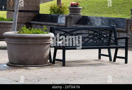 black wrought iron bench in park Stock Photo