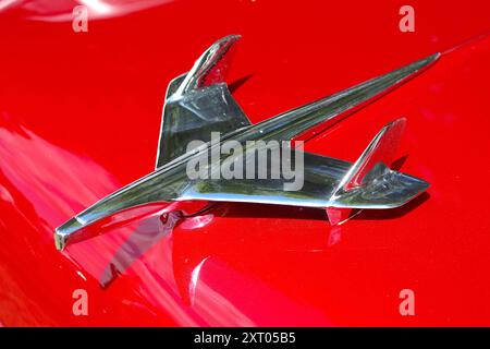 The chrome hood ornament (bonnet mascot) fitted to a 1955 Chevrolet Bel Air. The design being likened to a cross between an eagle and a jet plane. Stock Photo