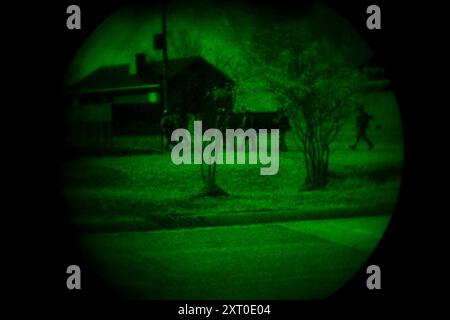 British Army reservists from the 3rd Battalion, Royal Anglian Regiment, known as “The Steelbacks,” conduct simulated urban operations and night attack during Exercise Northern Strike 24-2 at the Combined Armed Collective Training Facility, Camp Grayling, Michigan, Aug. 12, 2024. Northern Strike 24-2, one of the Department of Defense's largest reserve component readiness exercises, is scheduled to take place at Michigan's National All Domain Warfighting Center (NADWC) from August 3-17, 2024. Over 6,300 participants from 32 states and territories and several international participants will conve Stock Photo