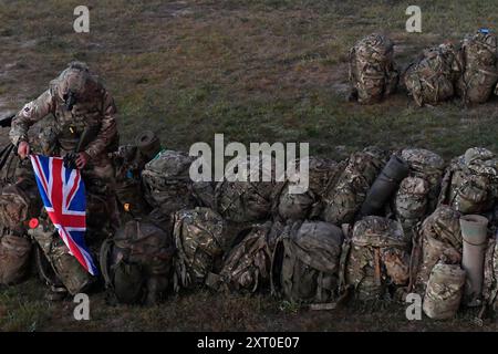 British Army reservists from the 3rd Battalion, Royal Anglian Regiment, known as “The Steelbacks,” conduct a simulated company-level urban operations night attack during Exercise Northern Strike 24-2 at the Combined Armed Collective Training Facility, Camp Grayling, Michigan, Aug. 12, 2024. Northern Strike 24-2, one of the Department of Defense's largest reserve component readiness exercises, is scheduled to take place at Michigan's National All Domain Warfighting Center (NADWC) from August 3-17, 2024. Over 6,300 participants from 32 states and territories and several international participant Stock Photo