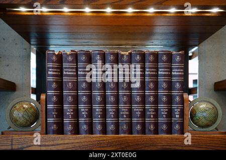 Old volumes of the Encyclopaedia Britannica or Encyclopedia Britannica lined up on a bookshelf Stock Photo