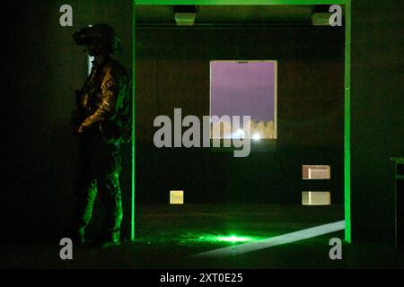 British Army reservists from the 3rd Battalion, Royal Anglian Regiment, known as “The Steelbacks,” conduct a simulated company-level urban operations night attack during Exercise Northern Strike 24-2 at the Combined Armed Collective Training Facility, Camp Grayling, Michigan, Aug. 12, 2024. Northern Strike 24-2, one of the Department of Defense's largest reserve component readiness exercises, is scheduled to take place at Michigan's National All Domain Warfighting Center (NADWC) from August 3-17, 2024. Over 6,300 participants from 32 states and territories and several international participant Stock Photo