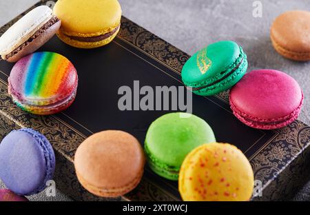 Variety of colorful macarons placed on an elegant decorative box, showcasing different flavors and vibrant colors. Stock Photo