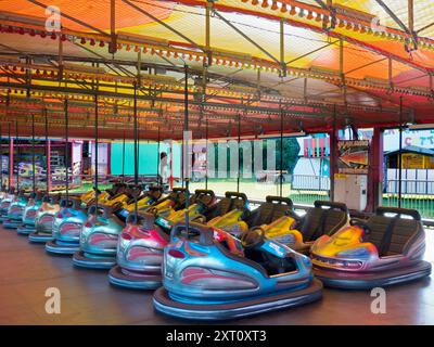 Here's a spooky sight - a deserted funfair. Not derelict, but seen at dawn, the only time you will see it like this. It's at Rye Farm Fields by the banks of the Thames at Abingdon on  a fine summer morning. And these, of course, are the dodgem carts, stationary for once. Stock Photo