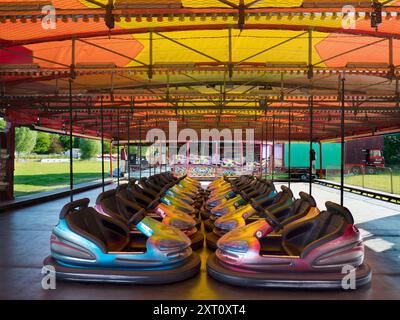 Here's a spooky sight - a deserted funfair. Not derelict, but seen at dawn, the only time you will see it like this. It's at Rye Farm Fields by the banks of the Thames at Abingdon on  a fine summer morning. And these, of course, are the dodgem carts, stationary for once. Stock Photo