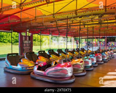 Here's a spooky sight - a deserted funfair. Not derelict, but seen at dawn, the only time you will see it like this. It's at Rye Farm Fields by the banks of the Thames at Abingdon on  a fine summer morning. And these, of course, are the dodgem carts, stationary for once. Stock Photo