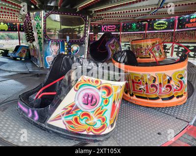 Here's a spooky site - a deserted funfair. Not derelict, but seen at dawn, the only time you will see it like this. It's at Rye Farm Fields by the banks of the Thames at Abingdon on  a fine summer morning.  This is a Waltzer, a rotating ride that often forms the centerpiece of English and Irish Fairs. It's a type of carousel, and also known as a Whirlygig. So there. Stock Photo