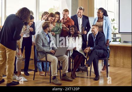 Large business team brainstorms ideas and shares interesting ideas during informal meeting. Stock Photo