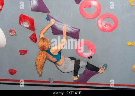 Young woman with curly hair engages in remote work at her comfortable ...