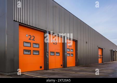 Red aluminum doors to  a black cargo building, Frederikssund, Denmark, January 2, 2018 Stock Photo