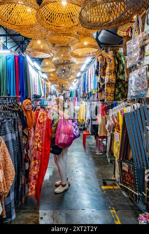 Penang Bazaar is an indoor market on Penang Road in Penang, Malaysia. Narrow passageways between stalls which mainly sell clothes and souvenirs Stock Photo