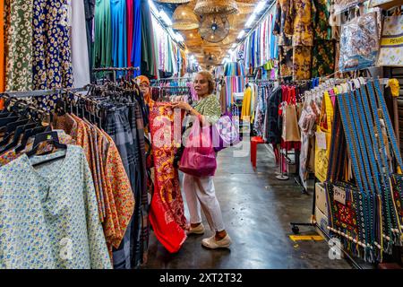 Penang Bazaar is an indoor market on Penang Road in Penang, Malaysia. Narrow passageways between stalls which mainly sell clothes and souvenirs Stock Photo