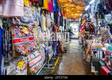 Penang Bazaar is an indoor market on Penang Road in Penang, Malaysia. Narrow passageways between stalls which mainly sell clothes and souvenirs Stock Photo